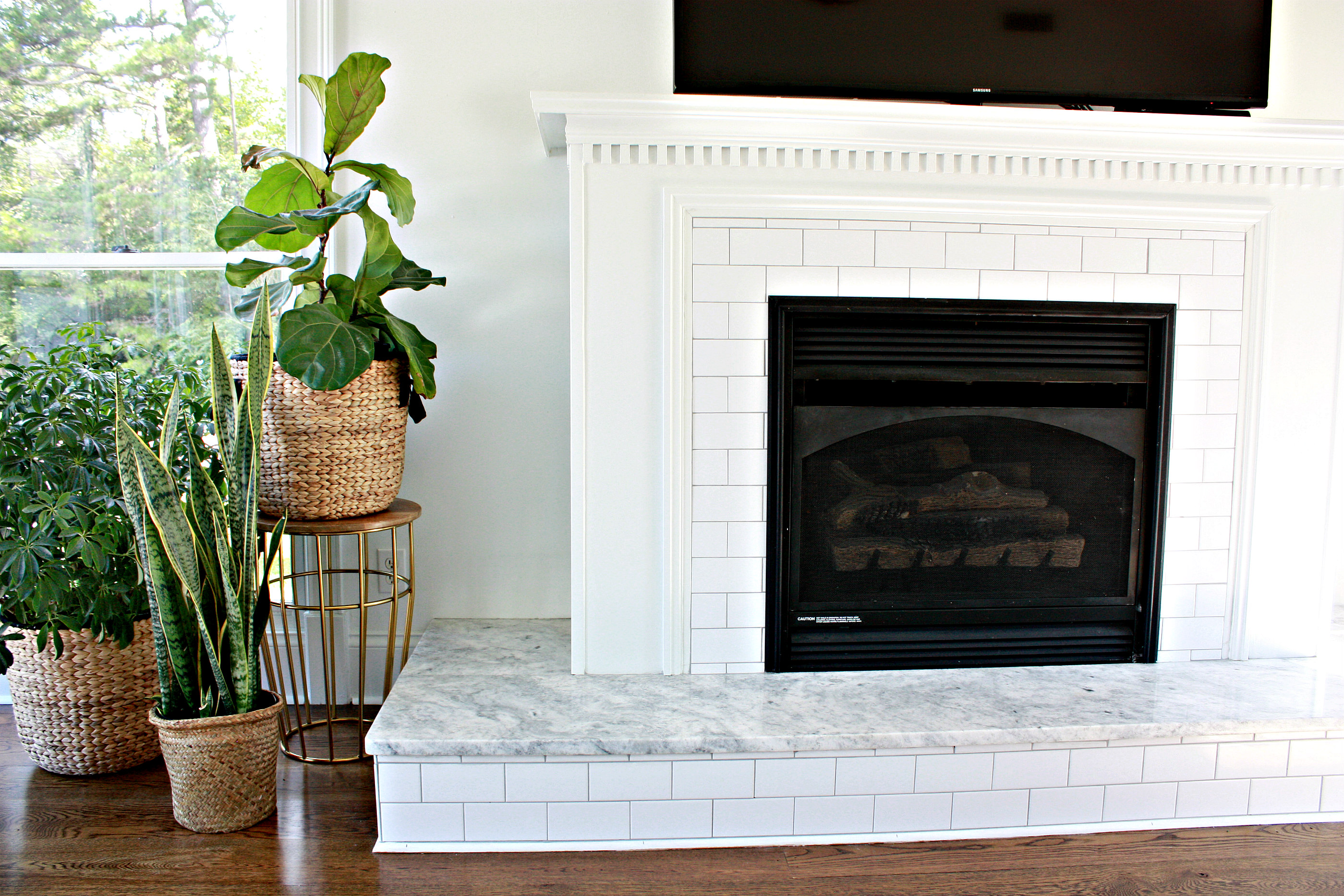 Fireplace with subway tile and Carrera Marble - Nest of Posies