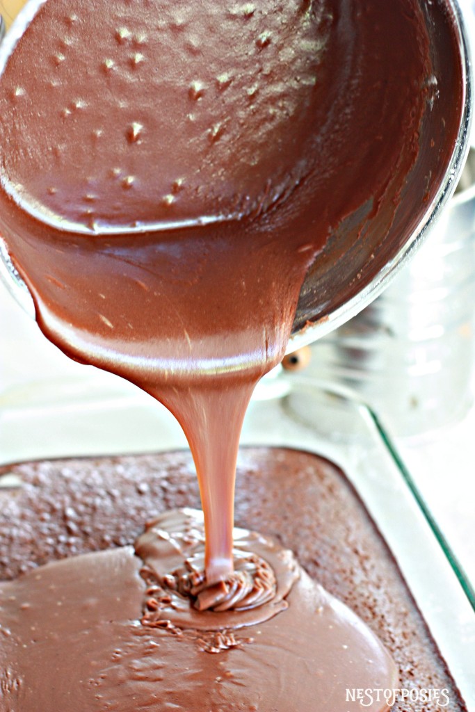 Pouring the warm homemade frosting over Grandma's Texas Sheet Cake